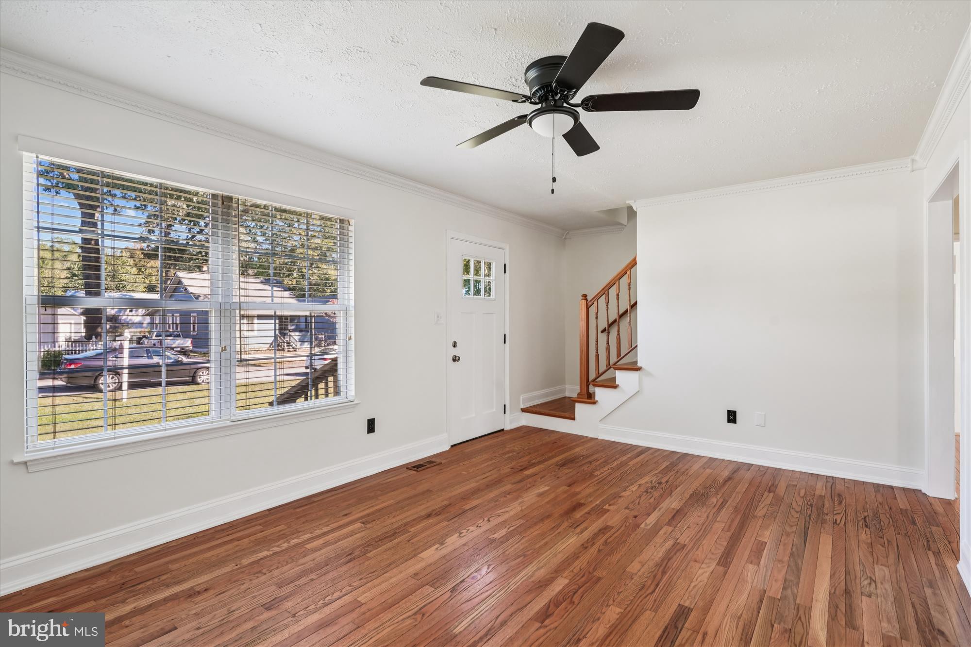 3831 8th Street North Beach, MD 20714 - Photo 3 of 37 a view of empty room with wooden floor and fan