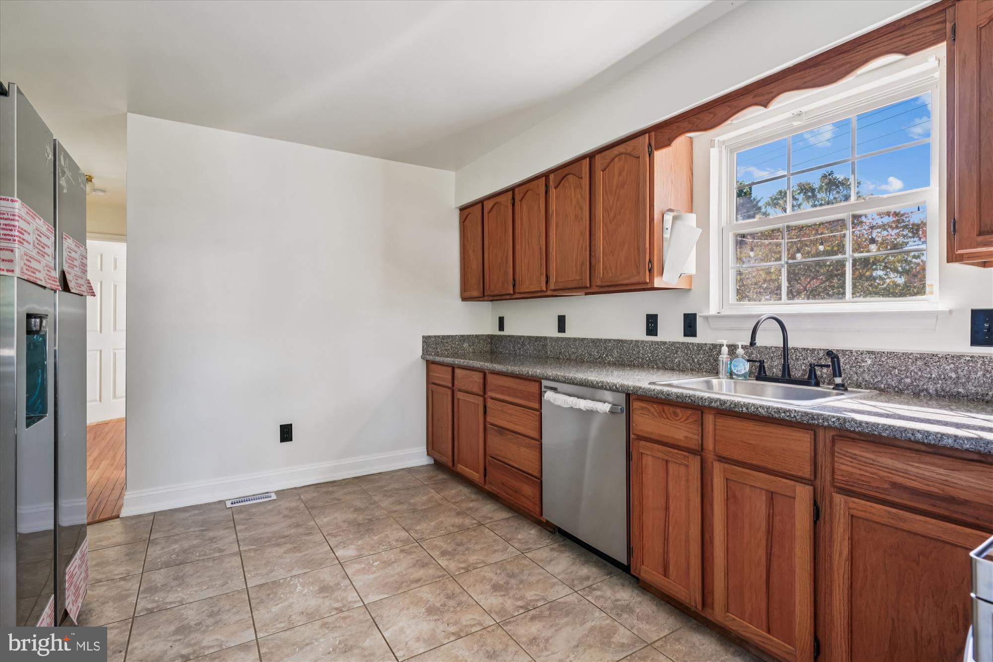 3831 8th Street North Beach, MD 20714 - Photo 5 of 37 a kitchen with stainless steel appliances granite countertop a sink stove and refrigerator