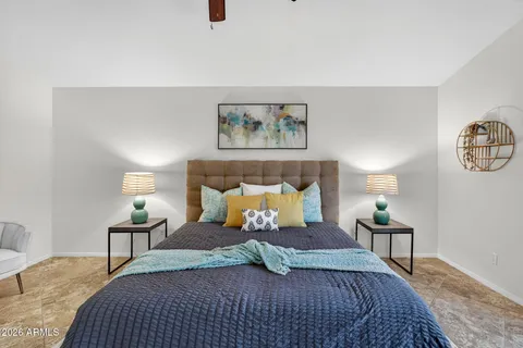 a bedroom with a large bed and a window