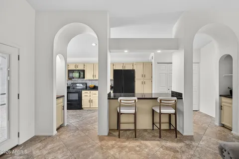 a kitchen with stainless steel appliances granite countertop a sink a stove a microwave a sink a refrigerator and cabinets