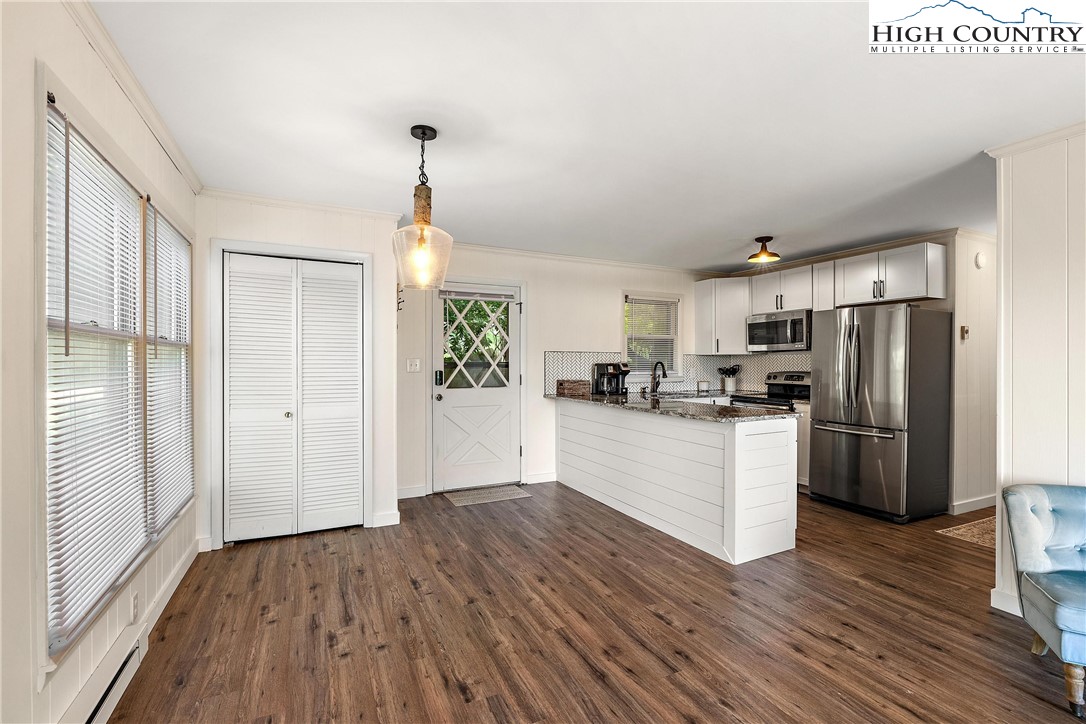 101 Mid Holiday Lane, Unit E217 Beech Mountain, NC 28604 - Photo 13 of 43 a kitchen with sink a refrigerator and wooden floor