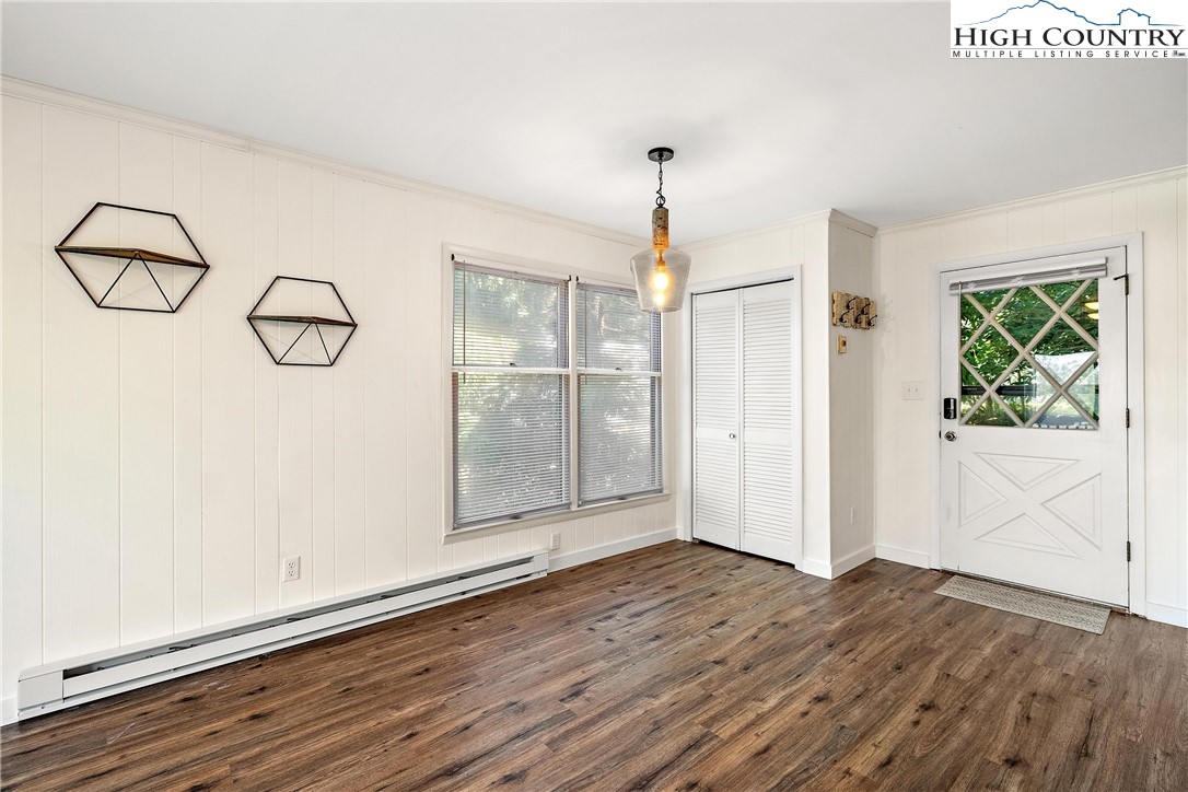 101 Mid Holiday Lane, Unit E217 Beech Mountain, NC 28604 - Photo 14 of 43 an empty room with wooden floor and windows