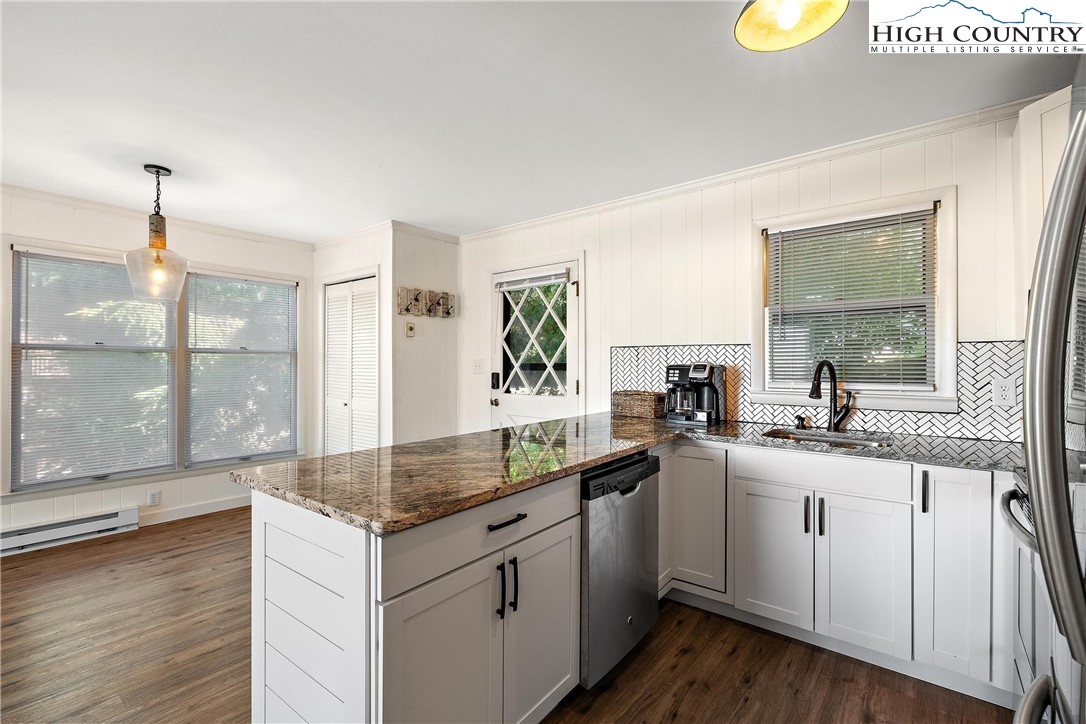 101 Mid Holiday Lane, Unit E217 Beech Mountain, NC 28604 - Photo 15 of 43 a kitchen with a sink cabinets and wooden floor