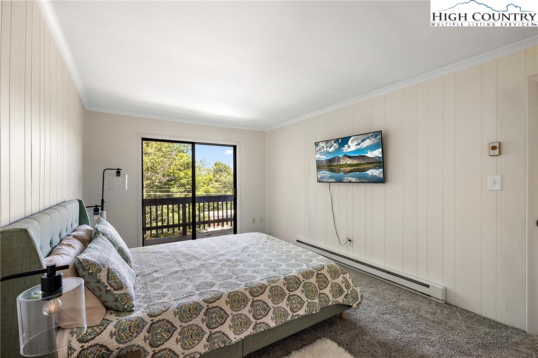 101 Mid Holiday Lane, Unit E217 Beech Mountain, NC 28604 - Photo 19 of 43 a bedroom with a bed and a window