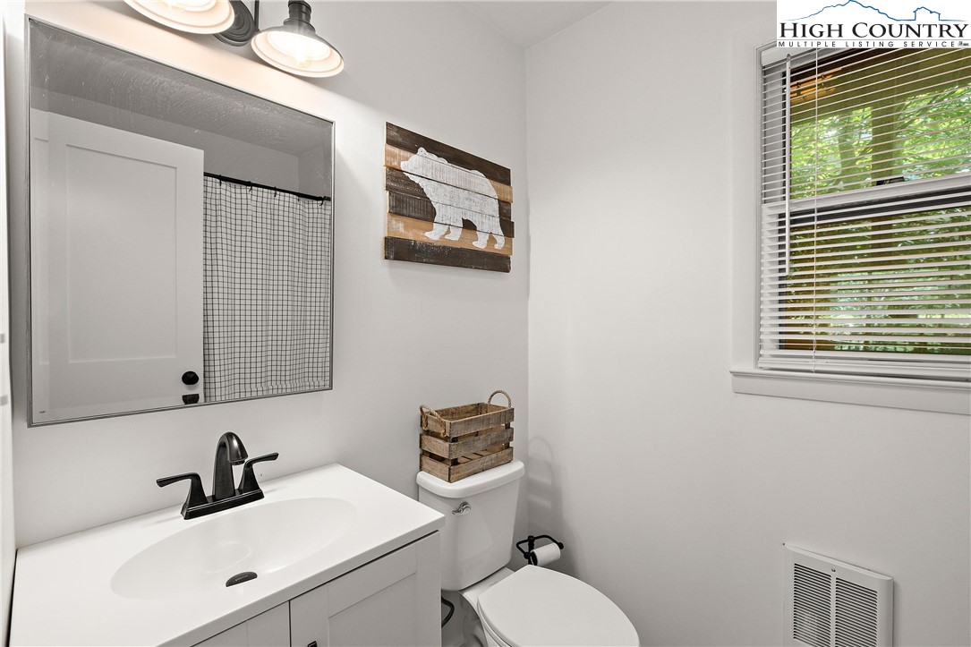 101 Mid Holiday Lane, Unit E217 Beech Mountain, NC 28604 - Photo 21 of 43 a bathroom with a toilet sink and mirror