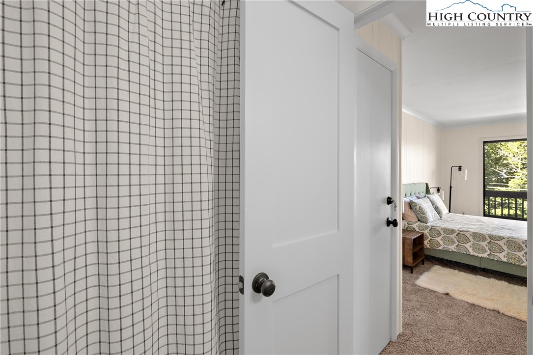 101 Mid Holiday Lane, Unit E217 Beech Mountain, NC 28604 - Photo 22 of 43 a view of a bedroom with a bed and a window