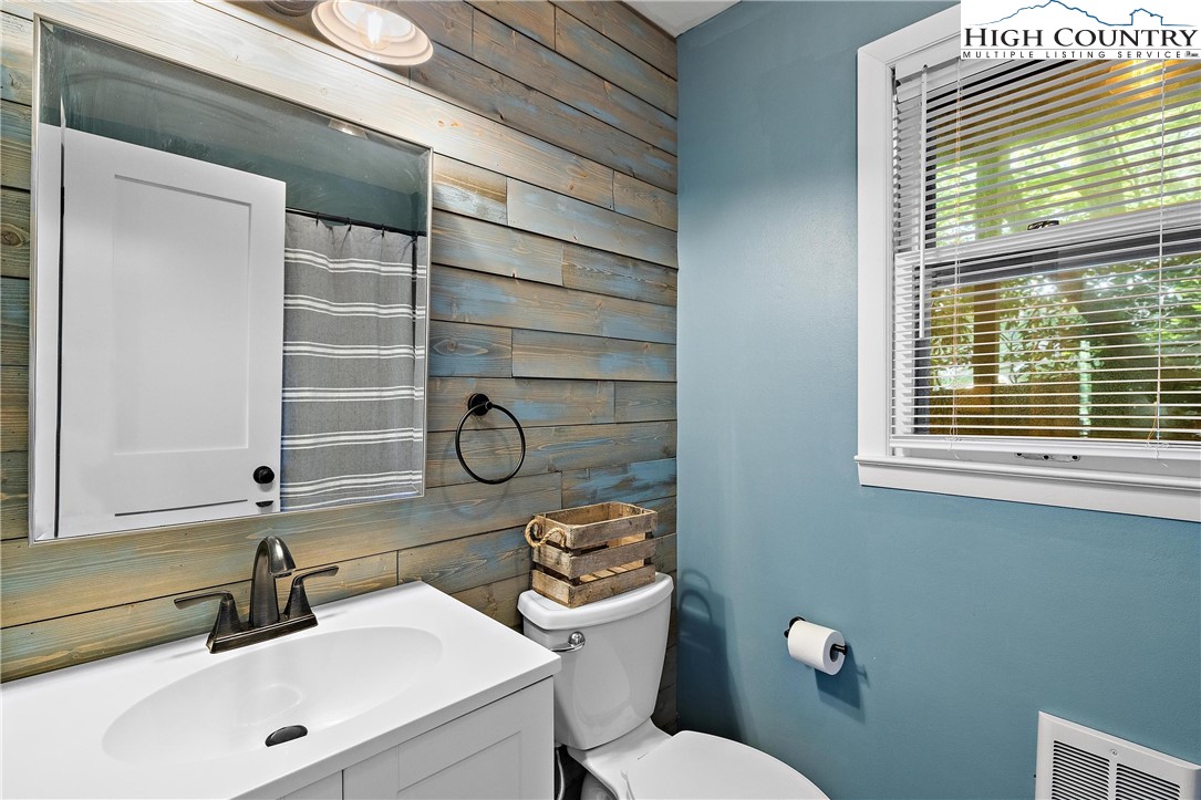 101 Mid Holiday Lane, Unit E217 Beech Mountain, NC 28604 - Photo 24 of 43 a bathroom with a sink a toilet and mirror