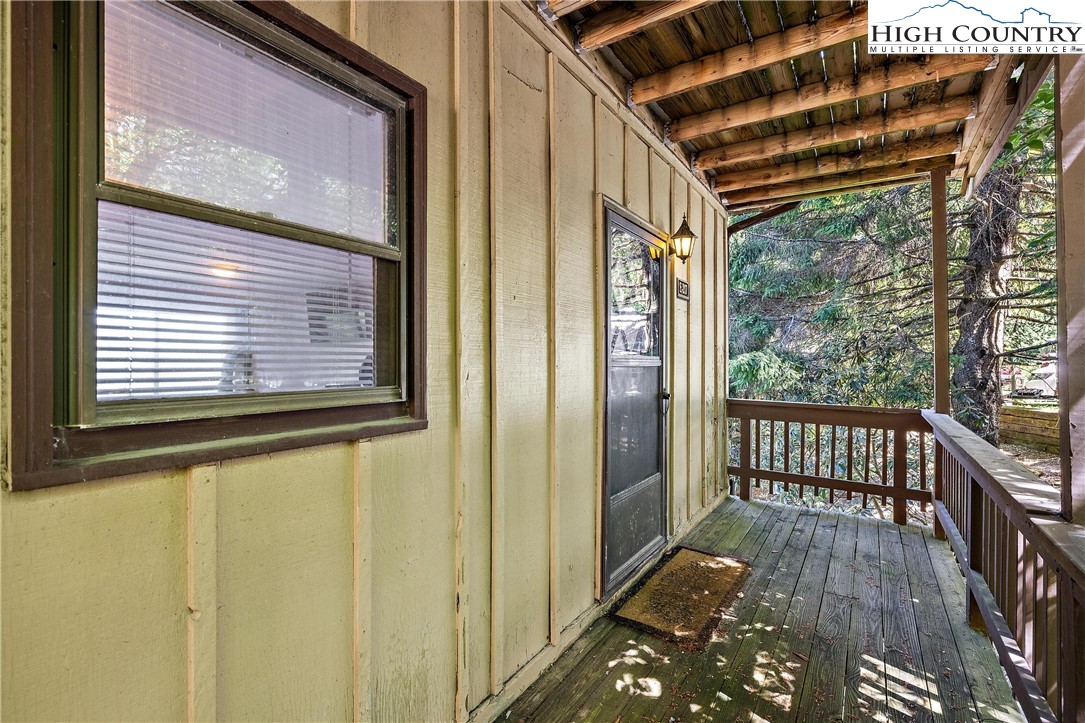 101 Mid Holiday Lane, Unit E217 Beech Mountain, NC 28604 - Photo 27 of 43 a view of a balcony with wooden floor