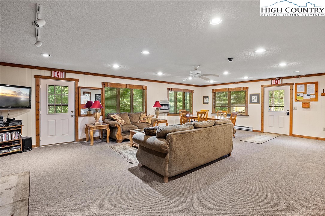 101 Mid Holiday Lane, Unit E217 Beech Mountain, NC 28604 - Photo 32 of 43 a living room with furniture and a flat screen tv