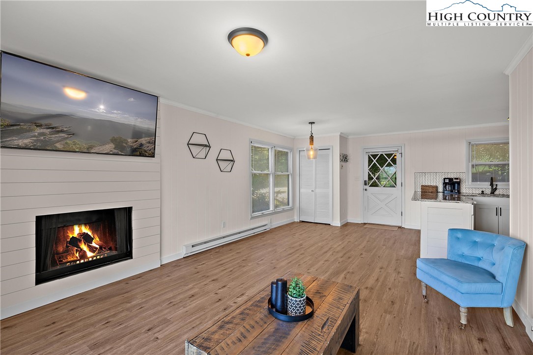 101 Mid Holiday Lane, Unit E217 Beech Mountain, NC 28604 - Photo 4 of 43 a living room with furniture and a fireplace