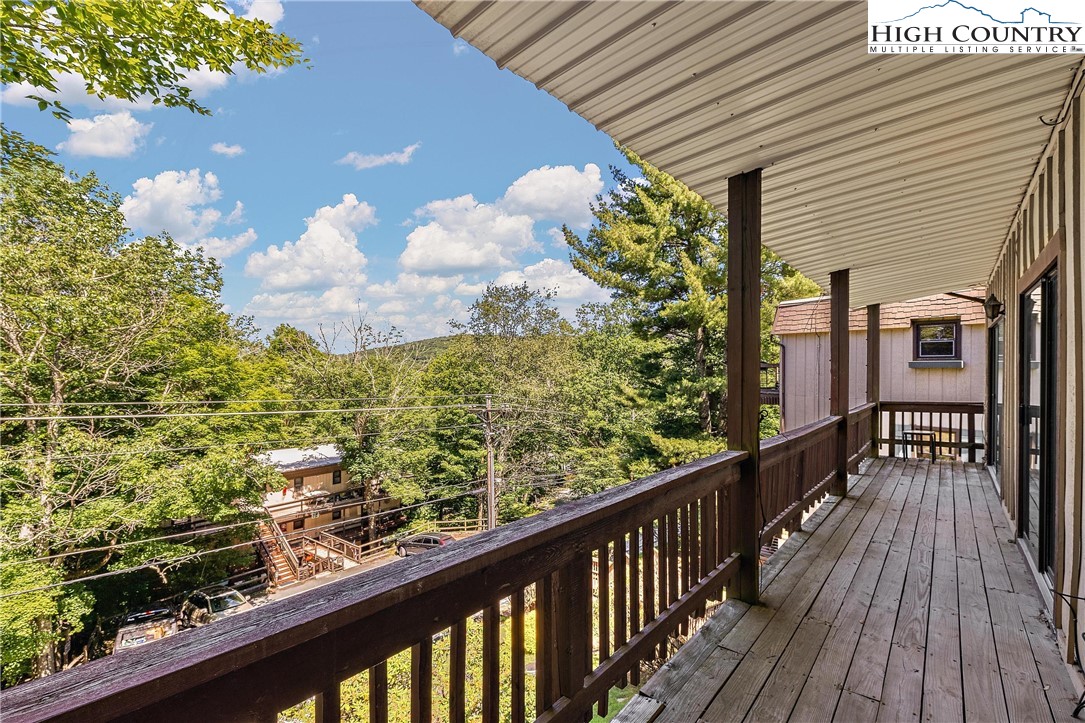 101 Mid Holiday Lane, Unit E217 Beech Mountain, NC 28604 - Photo 6 of 43 a view of a balcony with wooden floor