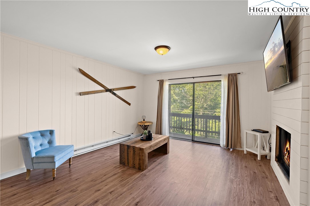 101 Mid Holiday Lane, Unit E217 Beech Mountain, NC 28604 - Photo 7 of 43 a living room with furniture and a flat screen tv