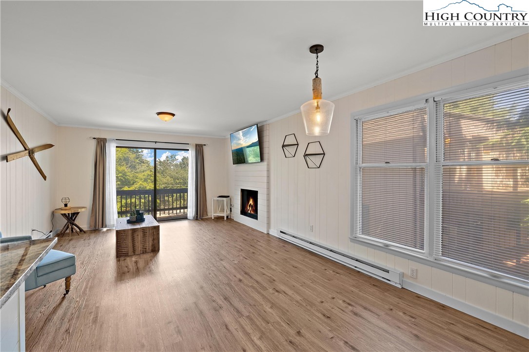 101 Mid Holiday Lane, Unit E217 Beech Mountain, NC 28604 - Photo 8 of 43 a view of a livingroom with furniture hardwood floor and windows