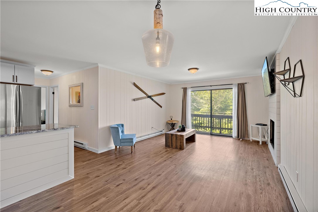 101 Mid Holiday Lane, Unit E217 Beech Mountain, NC 28604 - Photo 9 of 43 a living room with furniture and a wooden floor