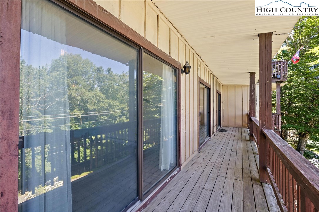 101 Mid Holiday Lane, Unit E217 Beech Mountain, NC 28604 - Photo 10 of 43 a view of a balcony with wooden floor