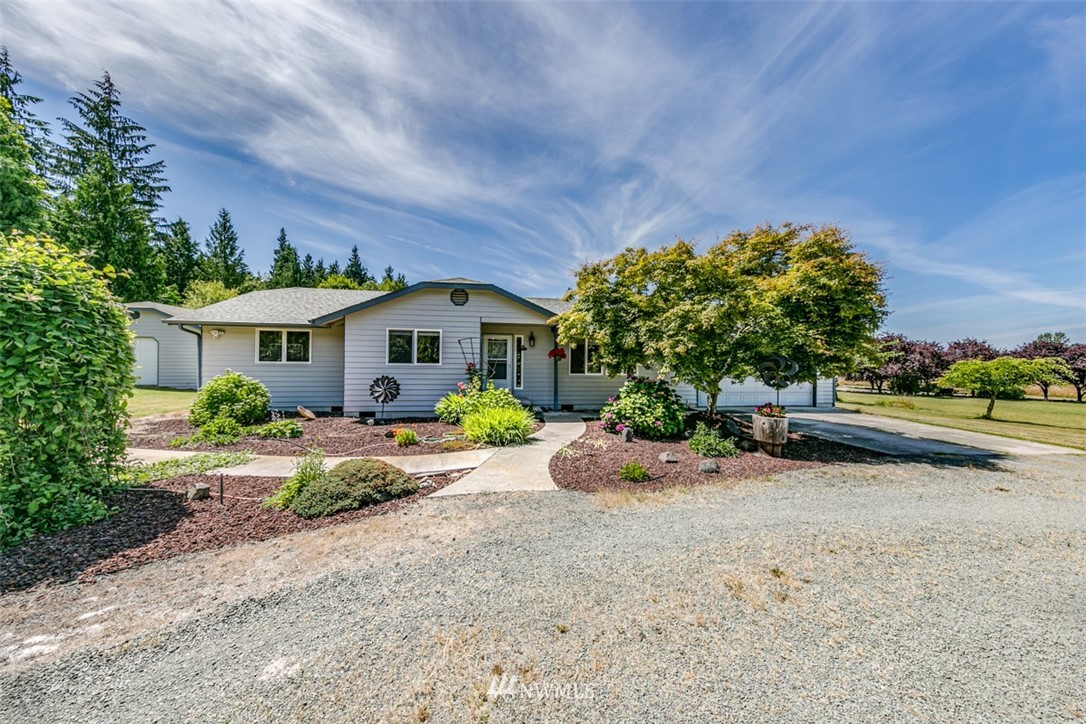422 Hulse Road Port Angeles, WA 98362 - Photo 3 of 40 a front view of a house with a yard and potted plants