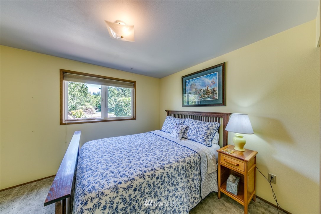 422 Hulse Road Port Angeles, WA 98362 - Photo 24 of 40 a bedroom with a bed and a painting on the wall