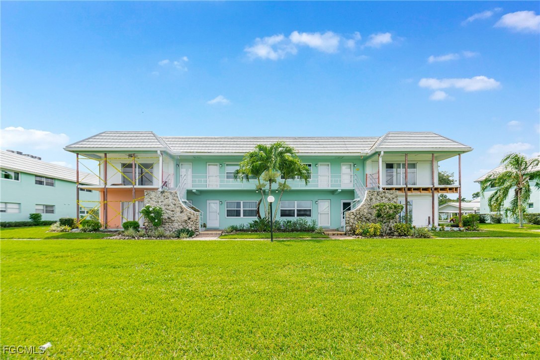 3225 East Riverside Drive, Unit 34C Fort Myers, FL 33916 - Photo 11 of 50 a view of a house with a big yard