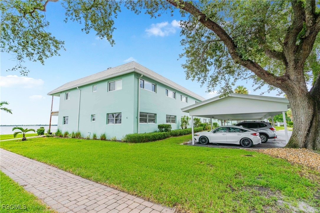 3225 East Riverside Drive, Unit 34C Fort Myers, FL 33916 - Photo 13 of 50 a front view of a house with garden