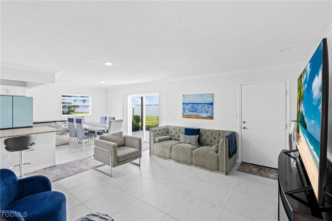 3225 East Riverside Drive, Unit 34C Fort Myers, FL 33916 - Photo 17 of 50 a living room with furniture a flat screen tv and a window