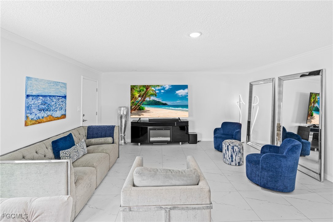 3225 East Riverside Drive, Unit 34C Fort Myers, FL 33916 - Photo 19 of 50 a living room with furniture ceiling fan and a window