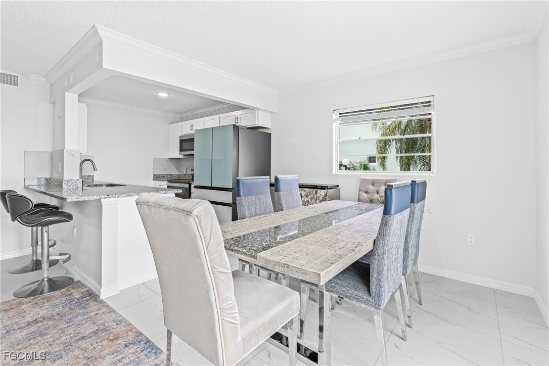3225 East Riverside Drive, Unit 34C Fort Myers, FL 33916 - Photo 21 of 50 a view of a dining room with furniture