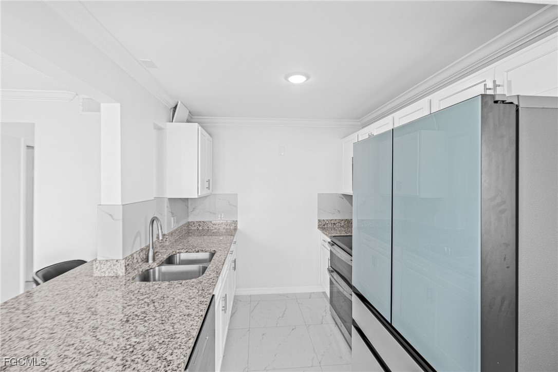 3225 East Riverside Drive, Unit 34C Fort Myers, FL 33916 - Photo 24 of 50 a kitchen with stainless steel appliances granite countertop a refrigerator and a sink