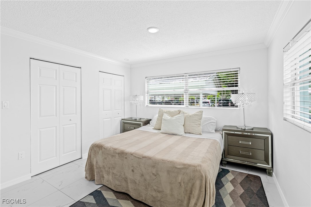 3225 East Riverside Drive, Unit 34C Fort Myers, FL 33916 - Photo 27 of 50 a bedroom with a bed and a window