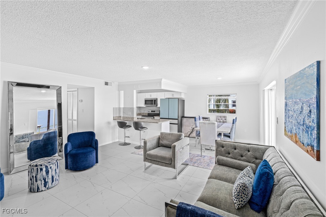 3225 East Riverside Drive, Unit 34C Fort Myers, FL 33916 - Photo 3 of 50 a living room with furniture and a large window