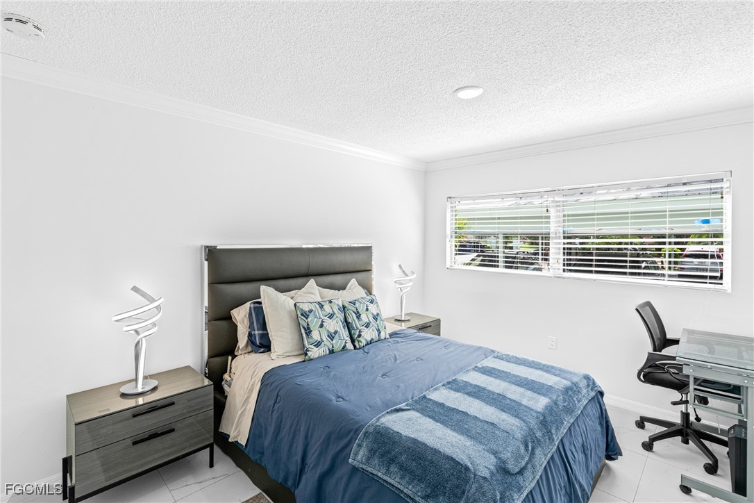 3225 East Riverside Drive, Unit 34C Fort Myers, FL 33916 - Photo 31 of 50 a bedroom with a bed and a desk