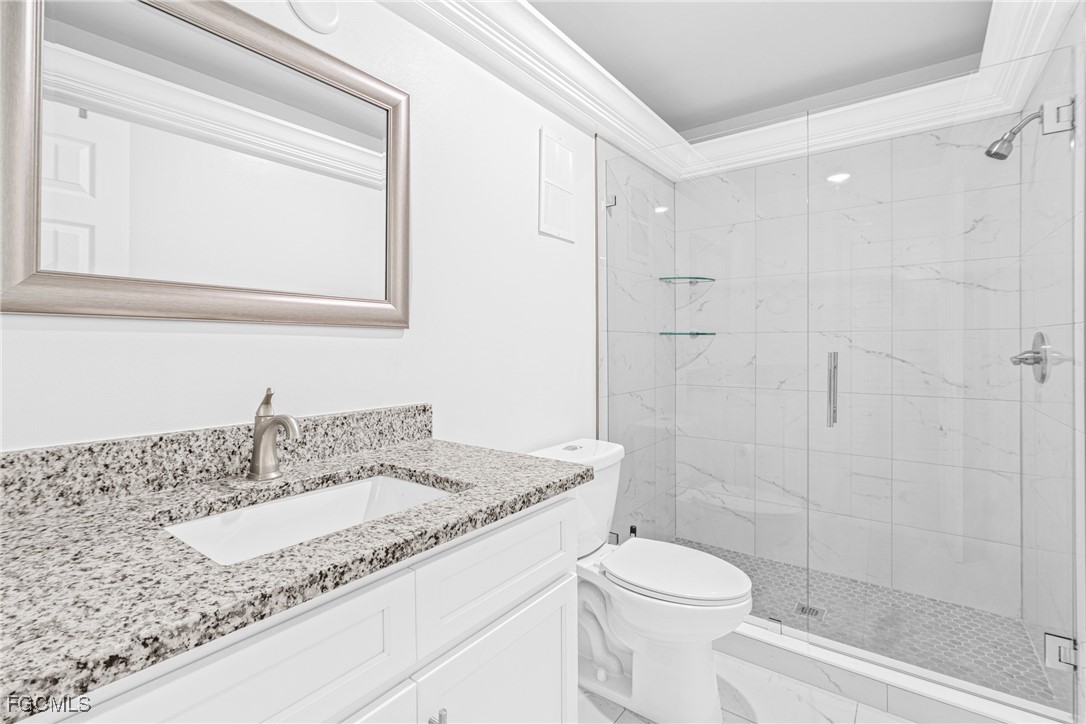 3225 East Riverside Drive, Unit 34C Fort Myers, FL 33916 - Photo 34 of 50 a bathroom with a granite countertop sink toilet and shower