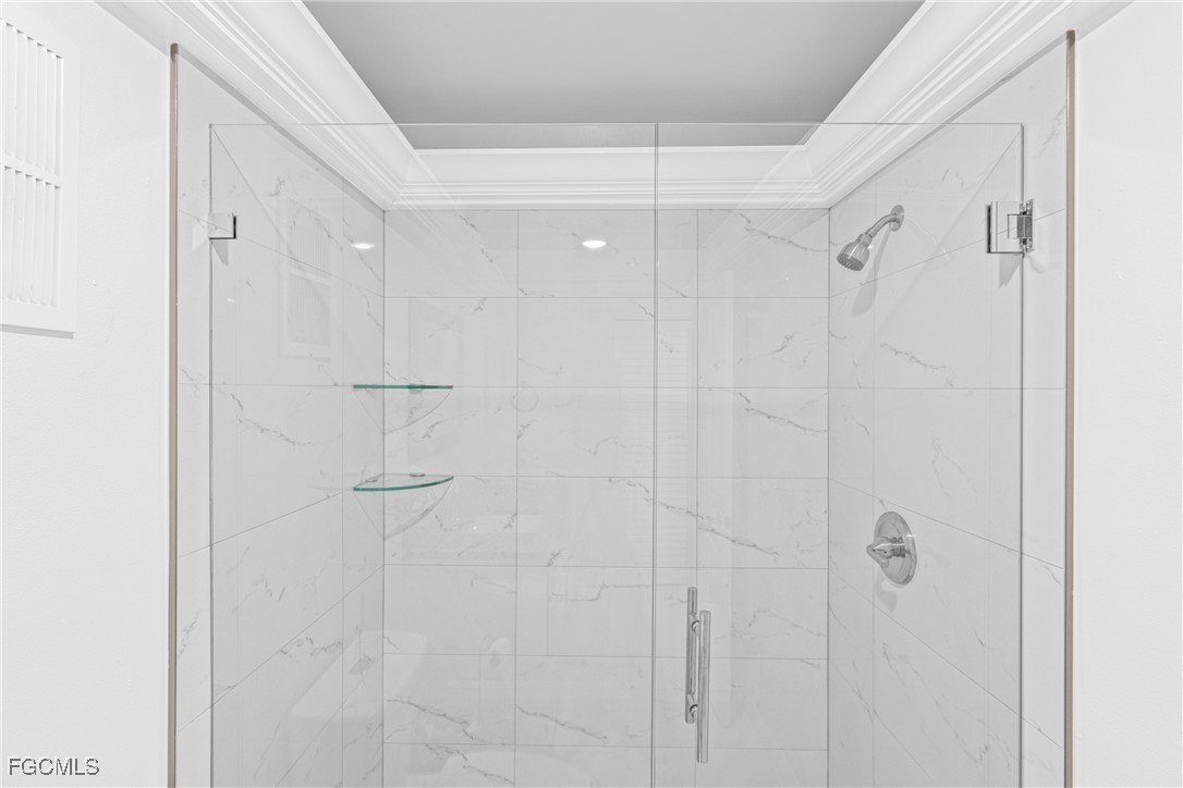 3225 East Riverside Drive, Unit 34C Fort Myers, FL 33916 - Photo 35 of 50 a bathroom with a glass shower door