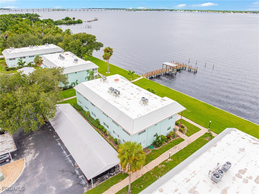 3225 East Riverside Drive, Unit 34C Fort Myers, FL 33916 - Photo 36 of 50 a view of a terrace with a table and chairs