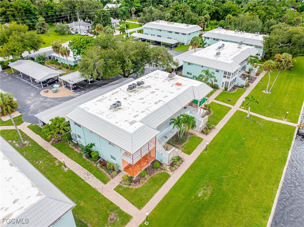 3225 East Riverside Drive, Unit 34C Fort Myers, FL 33916 - Photo 39 of 50 an aerial view of a house with a garden and swimming pool