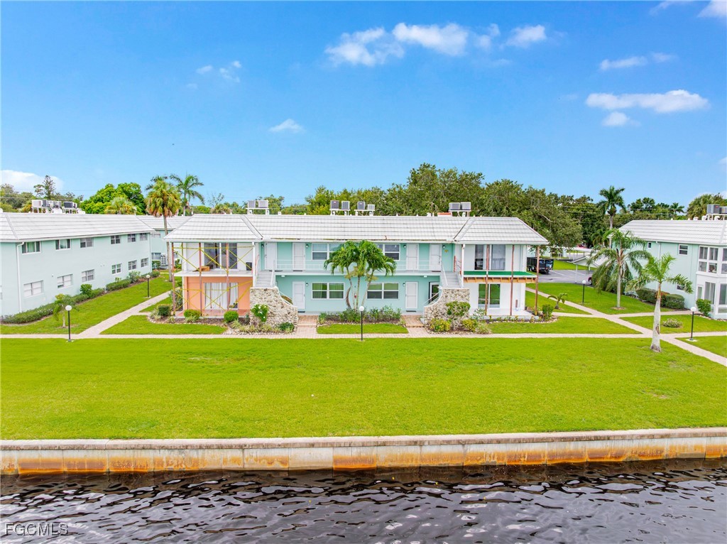 3225 East Riverside Drive, Unit 34C Fort Myers, FL 33916 - Photo 40 of 50 a view of a swimming pool with a garden