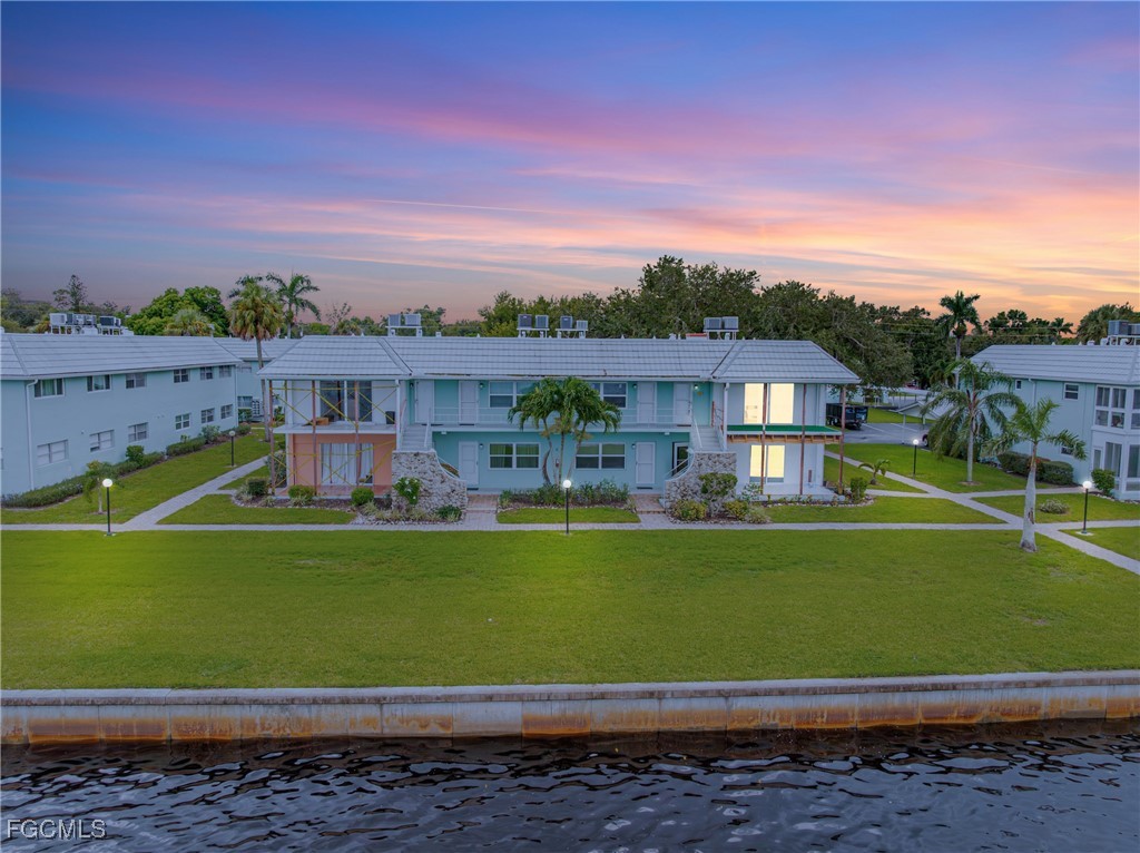 3225 East Riverside Drive, Unit 34C Fort Myers, FL 33916 - Photo 41 of 50 a view of a big house with a big yard