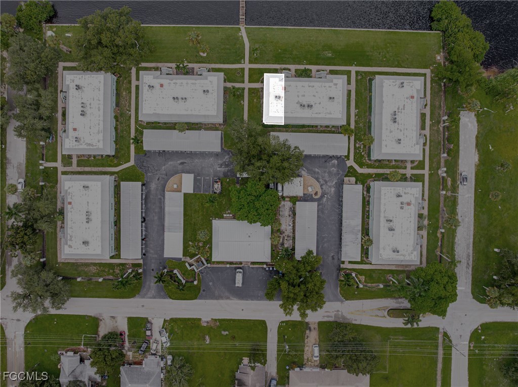 3225 East Riverside Drive, Unit 34C Fort Myers, FL 33916 - Photo 46 of 50 aerial view of a house with a yard and large tree