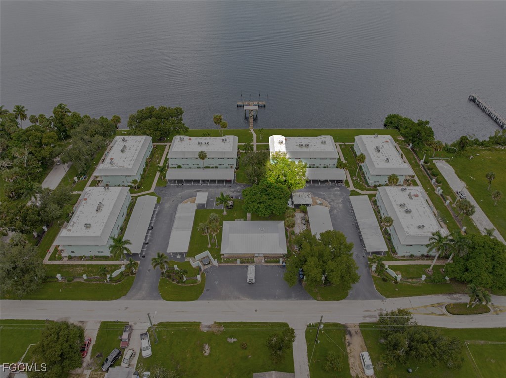 3225 East Riverside Drive, Unit 34C Fort Myers, FL 33916 - Photo 48 of 50 an aerial view of multiple houses with yard