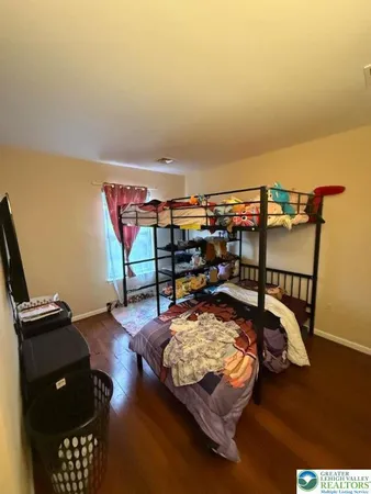 a bedroom with bed and a window