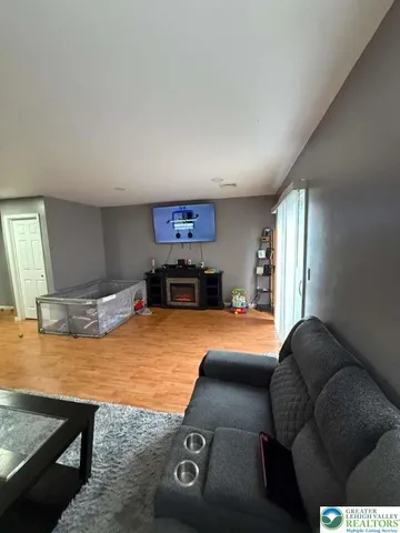 a living room with furniture and a pool table