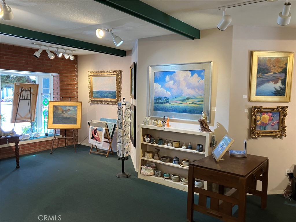 724 Main Street Cambria, CA 93428 - Photo 15 of 24 a living room filed with furniture and paintings on the wall