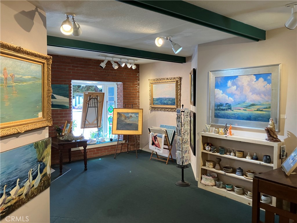 724 Main Street Cambria, CA 93428 - Photo 16 of 24 a room with furniture and flat screen tv