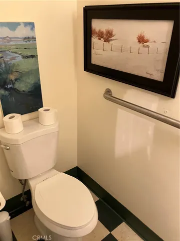 a white toilet sitting next to a sink