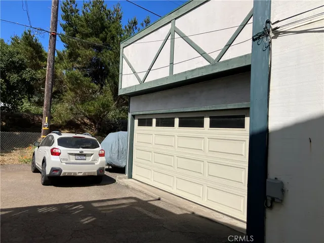 a white car parked in front of a house