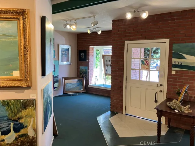 a view of a livingroom with furniture and windows