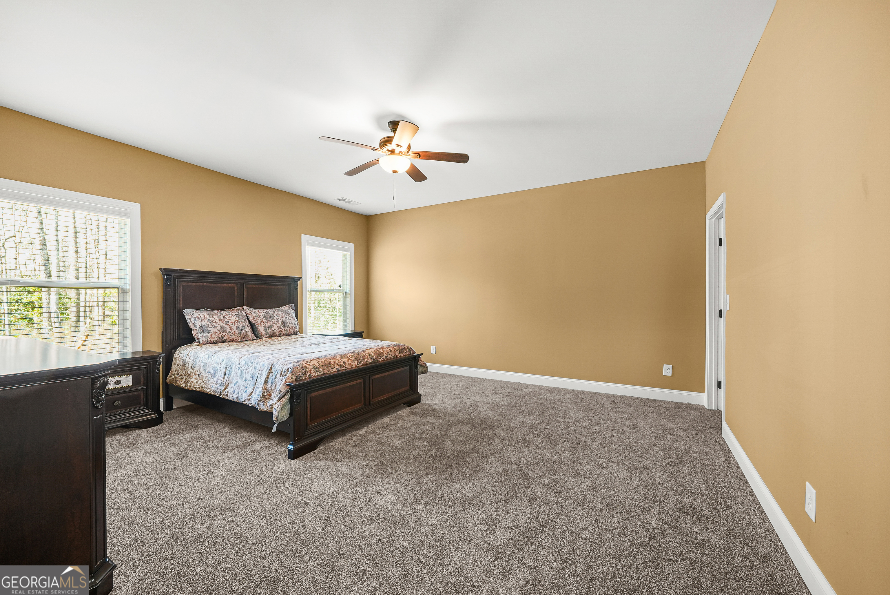 1663 Piedmont Road Griffin, GA 30224 - Photo 16 of 35 a spacious bedroom with a bed and a chandelier