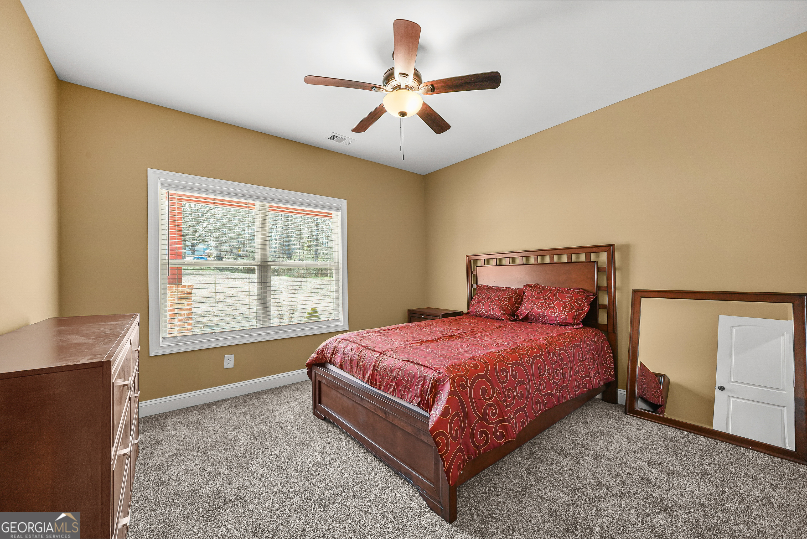 1663 Piedmont Road Griffin, GA 30224 - Photo 18 of 35 a spacious bedroom with a bed and window