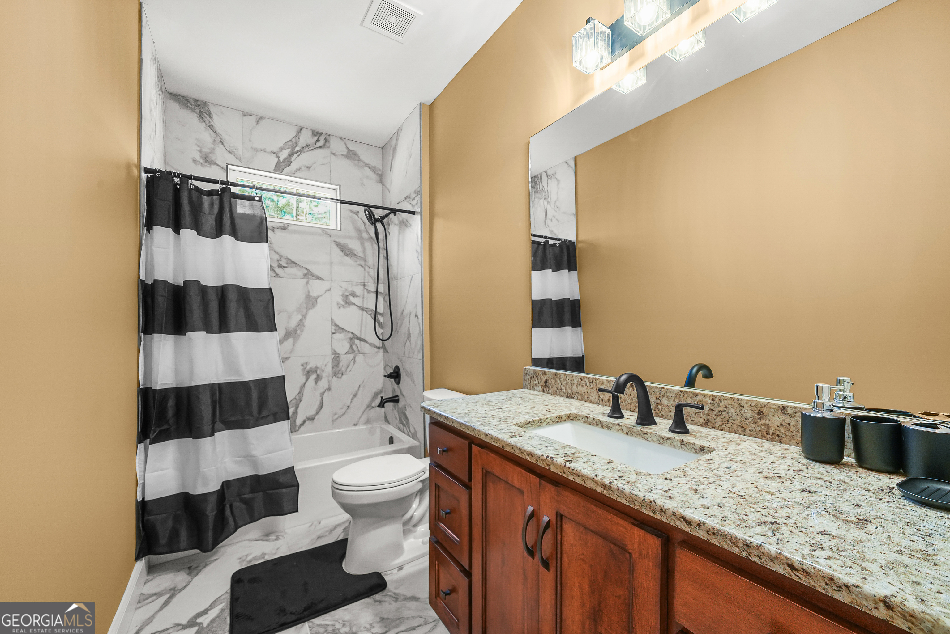 1663 Piedmont Road Griffin, GA 30224 - Photo 19 of 35 a bathroom with a granite countertop sink toilet and shower