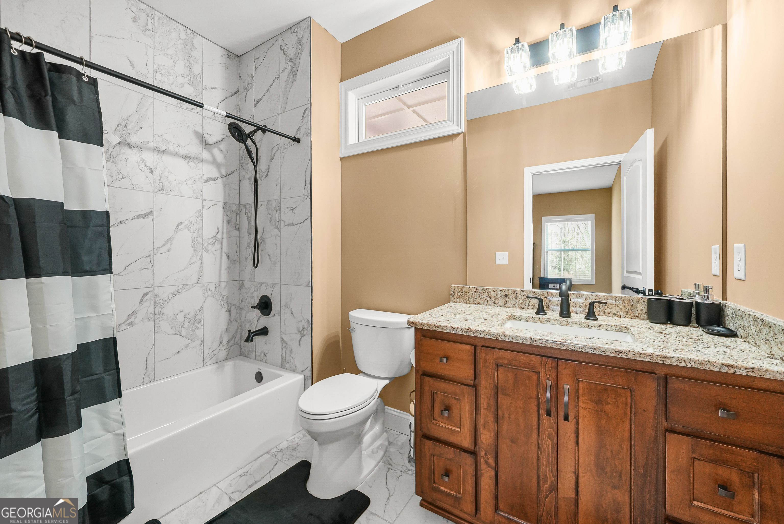 1663 Piedmont Road Griffin, GA 30224 - Photo 21 of 35 a bathroom with a granite countertop sink toilet and shower