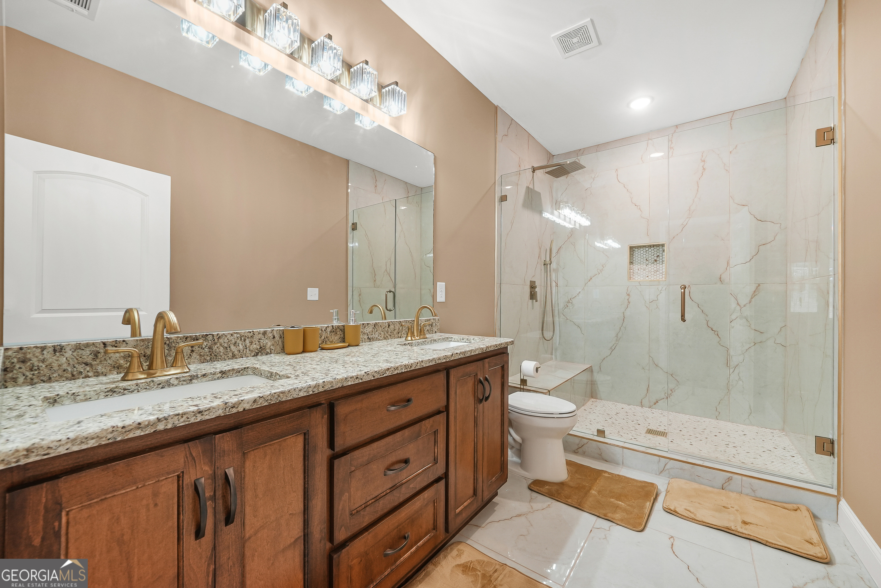 1663 Piedmont Road Griffin, GA 30224 - Photo 23 of 35 a bathroom with a granite countertop double vanity sink toilet mirror and shower